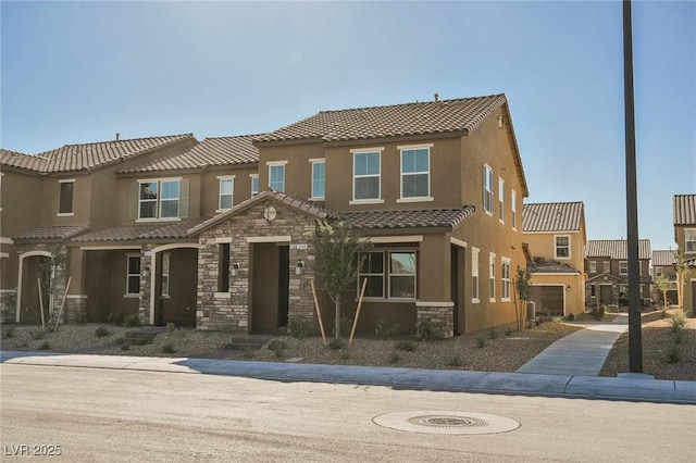 3240 Avernus Ave, Henderson, NV 89044 - view of property featuring stone siding, stucco siding, and a tiled roof