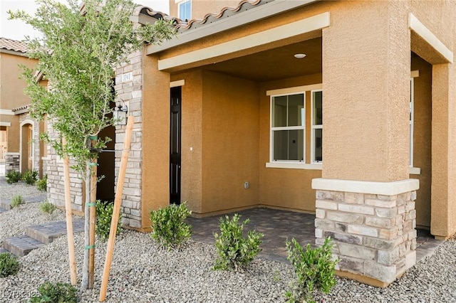 3240 Avernus Ave, Henderson, NV 89044 - property entrance with stucco siding, stone siding, and a tile roof