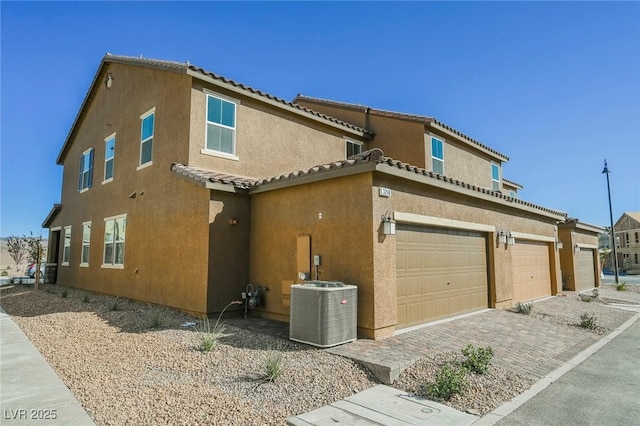 3240 Avernus Ave, Henderson, NV 89044 - view of side of home with stucco siding, a tile roof, driveway, and a garage