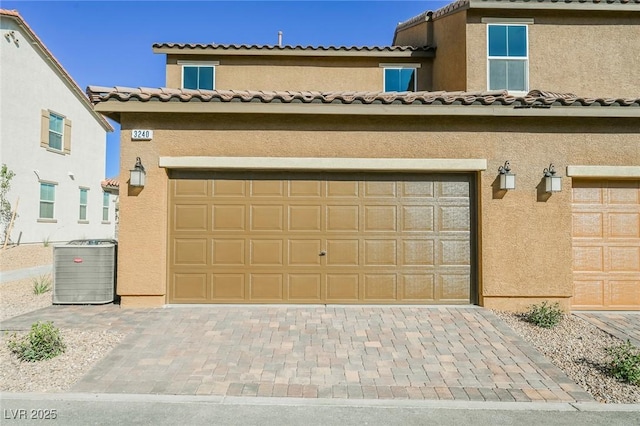 3240 Avernus Ave, Henderson, NV 89044 - view of front of property featuring stucco siding, a garage, decorative driveway, and a tile roof