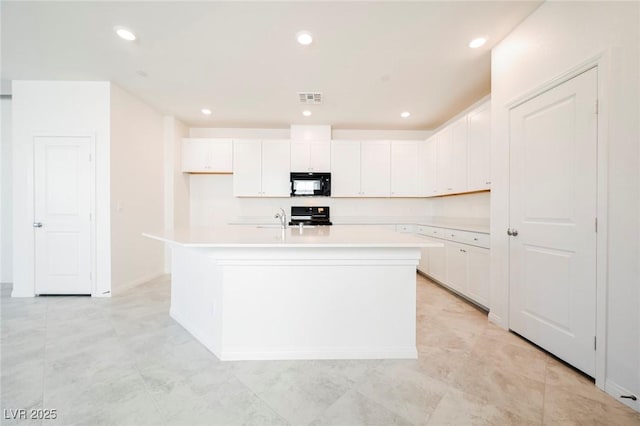 3240 Avernus Ave, Henderson, NV 89044 - kitchen featuring black microwave, stove, white cabinetry, and recessed lighting