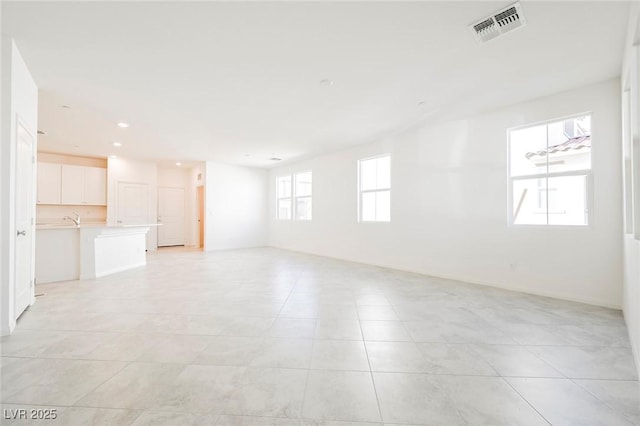 3240 Avernus Ave, Henderson, NV 89044 - unfurnished living room with light tile patterned flooring and recessed lighting