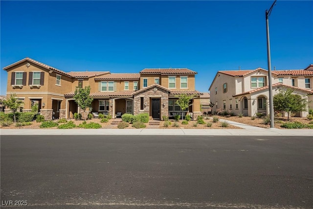 3240 Avernus Ave, Henderson, NV 89044 - view of front of house with a tiled roof, stone siding, stucco siding, and a porch