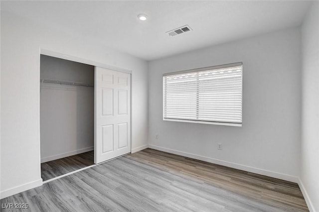 6346 Azurelyn Ave, Las Vegas, NV 89122 - unfurnished bedroom featuring wood finished floors, a closet, and recessed lighting