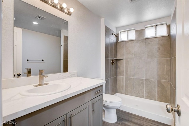 6346 Azurelyn Ave, Las Vegas, NV 89122 - bathroom featuring vanity, a tile shower, and wood finished floors