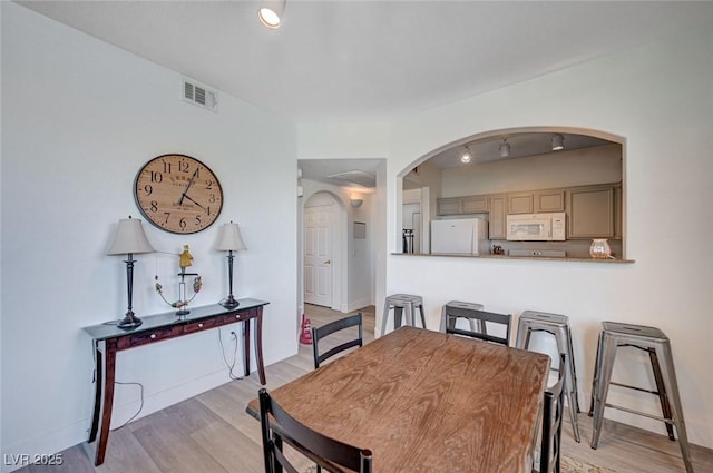 9975 Peace Way Unit 1024, Las Vegas, NV 89147 - dining room with arched walkways and light wood-style flooring