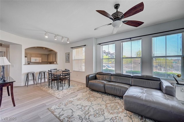 9975 Peace Way Unit 1024, Las Vegas, NV 89147 - living area featuring a ceiling fan, plenty of natural light, and light wood-style floors