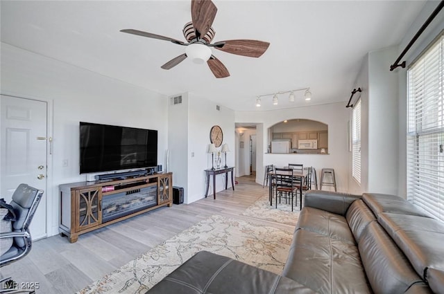 9975 Peace Way Unit 1024, Las Vegas, NV 89147 - living area featuring light wood-type flooring, ceiling fan, and arched walkways