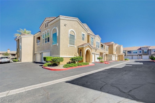 9975 Peace Way Unit 1024, Las Vegas, NV 89147 - view of front of home with a residential view, stucco siding, and an attached garage
