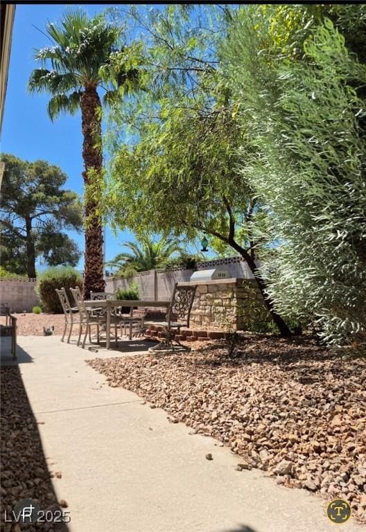 surrounding community with a patio and outdoor dining space