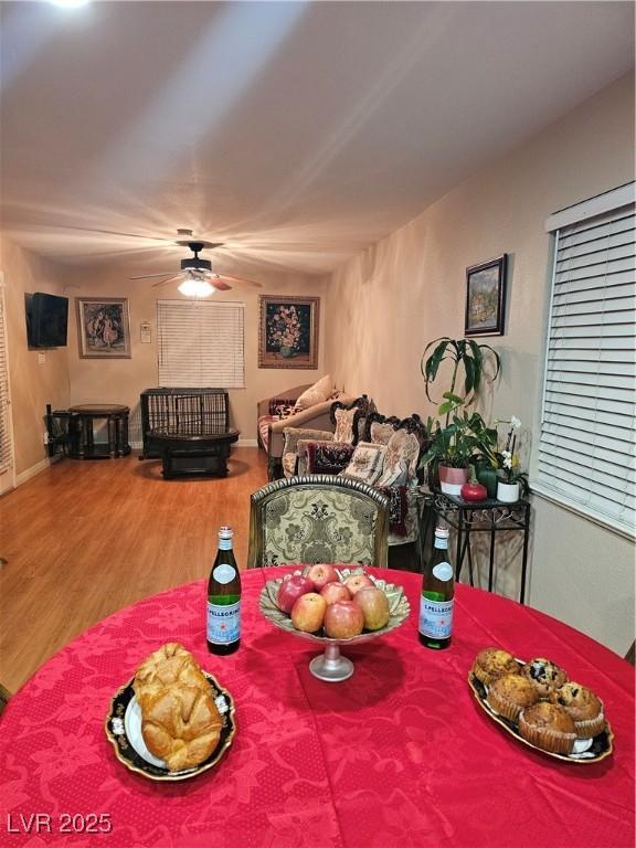 dining room featuring a ceiling fan and wood finished floors