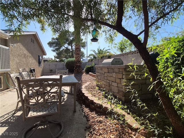 fenced backyard with outdoor dining space and a patio area