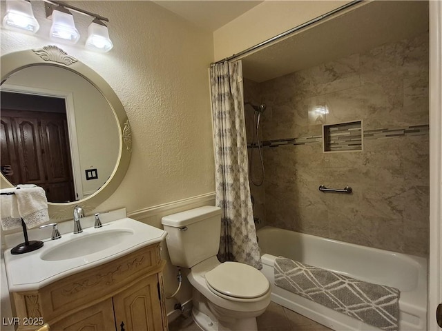 full bathroom with shower / bath combo, vanity, and a textured wall