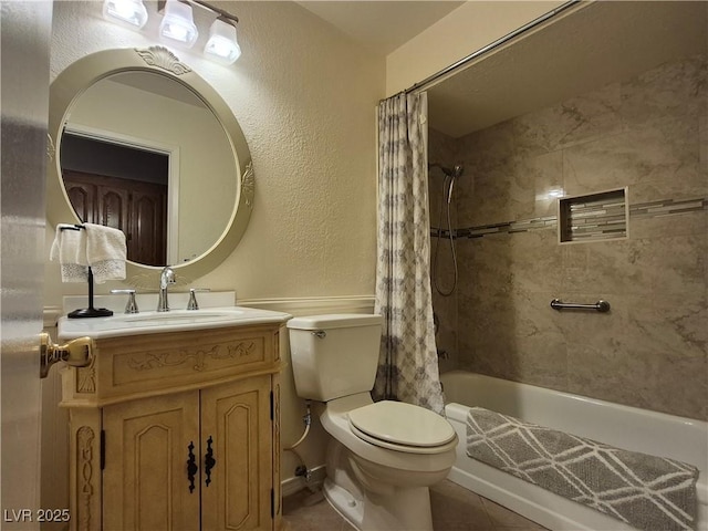full bath featuring vanity, shower / tub combo with curtain, and a textured wall