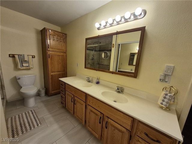 full bath with a stall shower, double vanity, and tile patterned floors