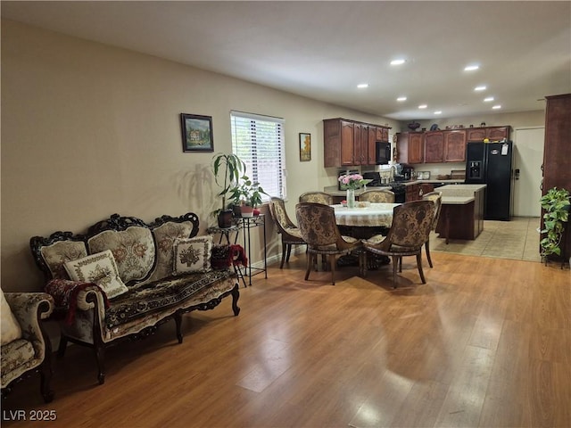 dining area featuring light wood-style flooring and recessed lighting