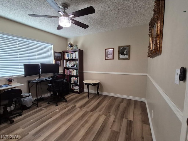 office space with a textured ceiling, ceiling fan, and wood finished floors