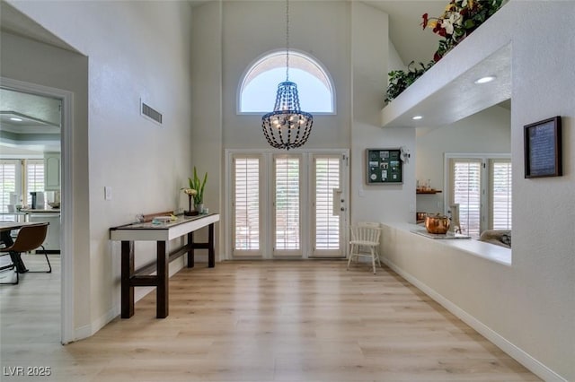 5133 Southern Hills Ln, Las Vegas, NV 89113 - foyer featuring light wood-type flooring, a chandelier, and a towering ceiling