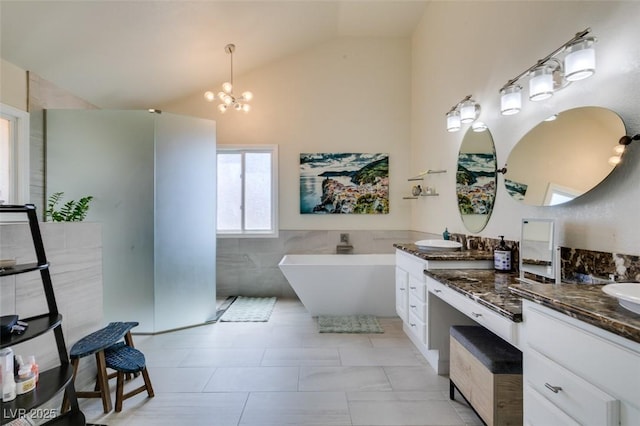 5133 Southern Hills Ln, Las Vegas, NV 89113 - full bath featuring double vanity, a freestanding bath, a chandelier, tile walls, and tile patterned floors