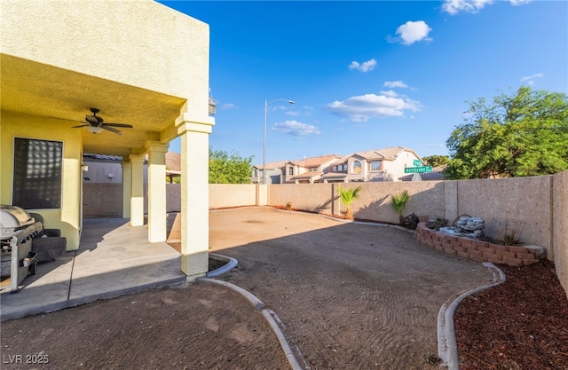 5907 Soft Mist Ct, Las Vegas, NV 89110 - fenced backyard featuring ceiling fan and a patio area
