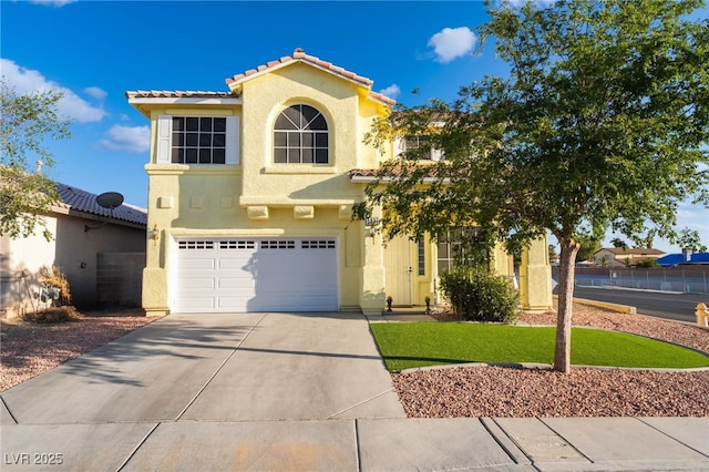 5907 Soft Mist Ct, Las Vegas, NV 89110 - mediterranean / spanish home with a tiled roof, stucco siding, concrete driveway, and a garage