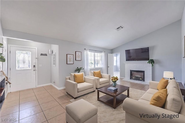 905 Smith St, Las Vegas, NV 89108 - living room with light tile patterned floors, vaulted ceiling, and a fireplace