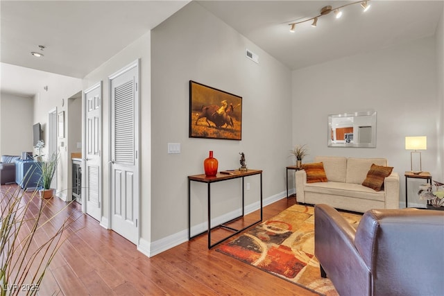 150 Las Vegas Blvd Unit 1906, Las Vegas, NV 89101 - living room featuring hardwood / wood-style floors and rail lighting