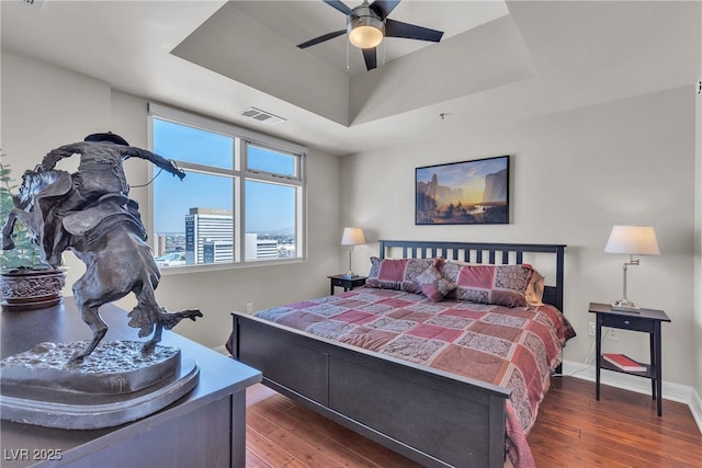 150 Las Vegas Blvd Unit 1906, Las Vegas, NV 89101 - bedroom featuring hardwood / wood-style flooring, a raised ceiling, and ceiling fan