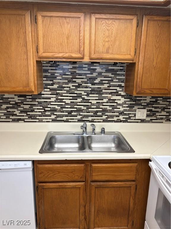 925 Falconhead Ln Unit 102, Las Vegas, NV 89128 - kitchen with white appliances, light countertops, and backsplash