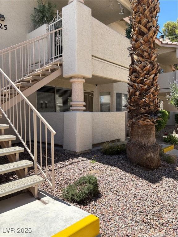 925 Falconhead Ln Unit 102, Las Vegas, NV 89128 - view of side of property with stairs and stucco siding