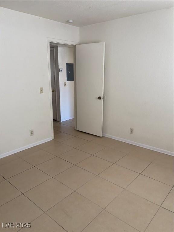 925 Falconhead Ln Unit 102, Las Vegas, NV 89128 - spare room featuring electric panel, light tile patterned floors, and a smoke detector