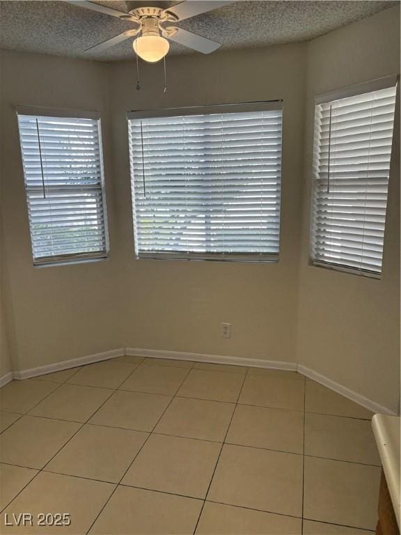 925 Falconhead Ln Unit 102, Las Vegas, NV 89128 - empty room with light tile patterned flooring, ceiling fan, and healthy amount of natural light