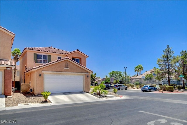 5516 Tantalum Ln, Las Vegas, NV 89122 - view of front of house with a tile roof, stucco siding, an attached garage, and concrete driveway