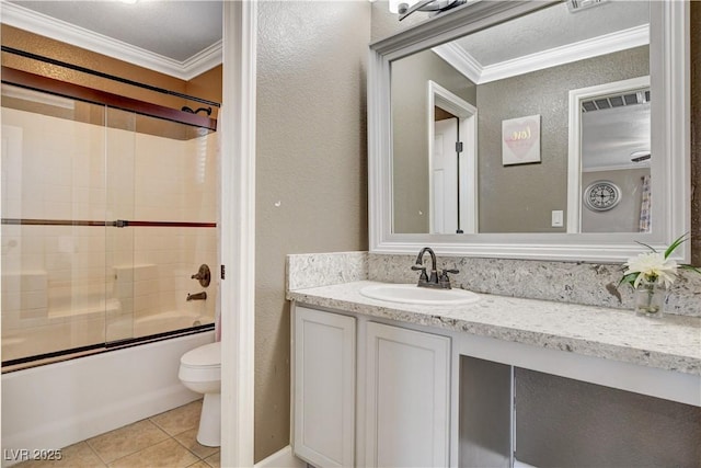 5516 Tantalum Ln, Las Vegas, NV 89122 - bathroom featuring ornamental molding, vanity, tile patterned floors, bath / shower combo with glass door, and a textured wall