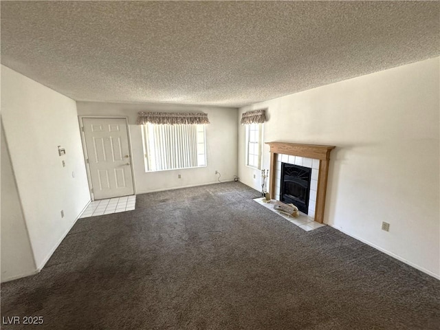 9070 Spring Mountain Rd Unit 109, Las Vegas, NV 89117 - unfurnished living room with carpet, a textured ceiling, and a tile fireplace