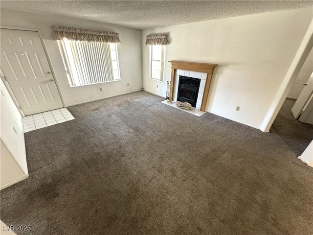 9070 Spring Mountain Rd Unit 109, Las Vegas, NV 89117 - unfurnished living room featuring carpet flooring, a textured ceiling, and a fireplace