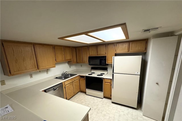 9070 Spring Mountain Rd Unit 109, Las Vegas, NV 89117 - kitchen with white appliances, light countertops, brown cabinets, and light floors