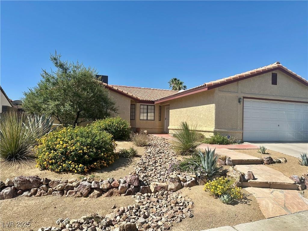 6357 Cobalt Ln, Las Vegas, NV 89146 - ranch-style home with a tile roof, stucco siding, an attached garage, and concrete driveway