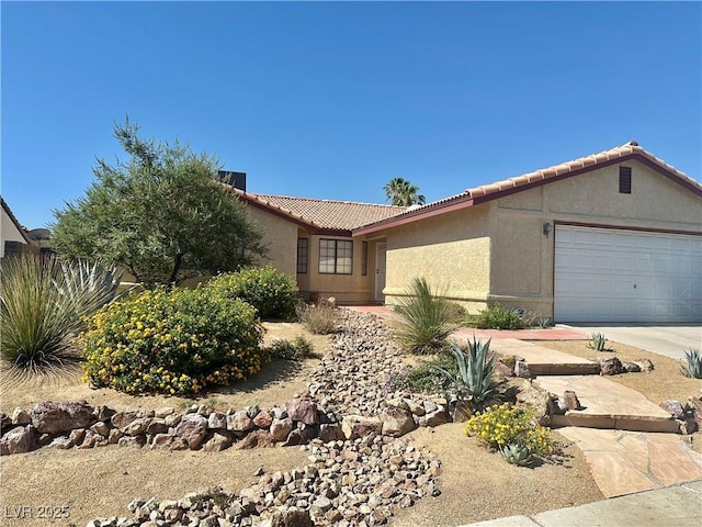 6357 Cobalt Ln, Las Vegas, NV 89146 - ranch-style home with a tile roof, stucco siding, an attached garage, and concrete driveway