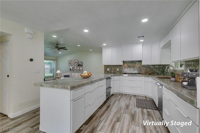 3708 Lorraine Ln, Las Vegas, NV 89120 - kitchen with a peninsula, light wood-style flooring, decorative backsplash, white cabinetry, and recessed lighting