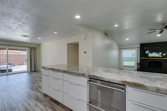3708 Lorraine Ln, Las Vegas, NV 89120 - kitchen featuring healthy amount of natural light, ceiling fan, stainless steel dishwasher, white cabinetry, and recessed lighting