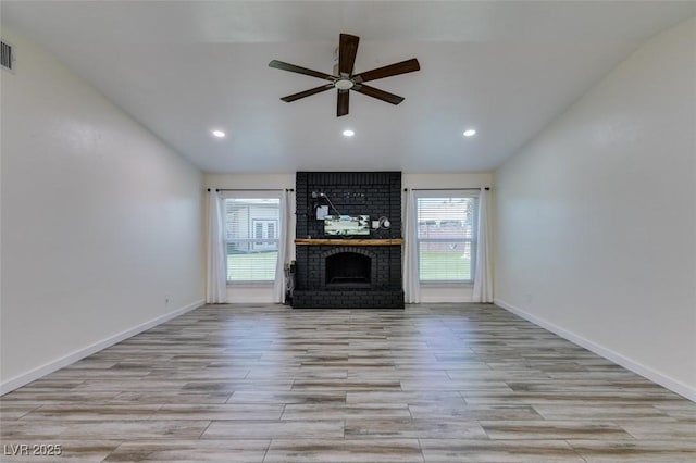 3708 Lorraine Ln, Las Vegas, NV 89120 - unfurnished living room featuring vaulted ceiling, ceiling fan, a brick fireplace, wood finished floors, and recessed lighting