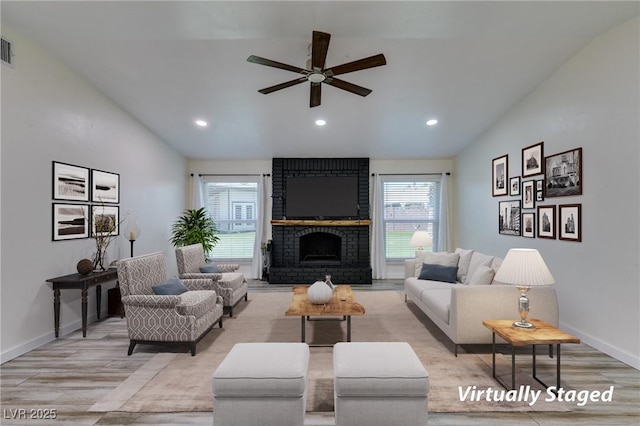 3708 Lorraine Ln, Las Vegas, NV 89120 - living area with vaulted ceiling, light wood-style floors, ceiling fan, a fireplace, and recessed lighting