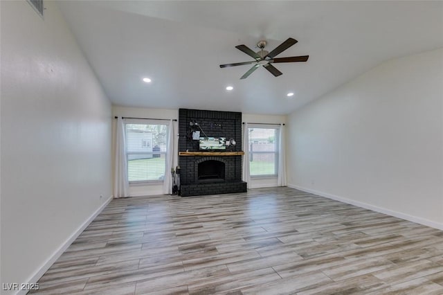3708 Lorraine Ln, Las Vegas, NV 89120 - unfurnished living room with lofted ceiling, plenty of natural light, ceiling fan, a brick fireplace, and wood finished floors