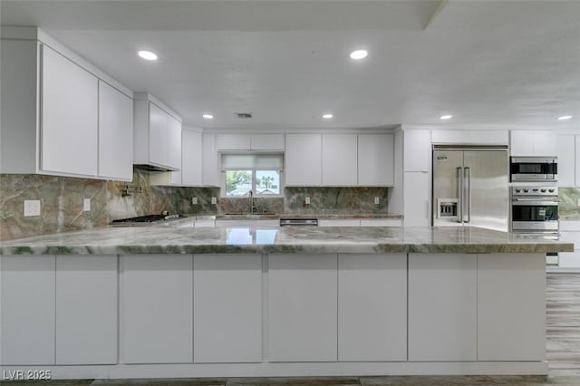 3708 Lorraine Ln, Las Vegas, NV 89120 - kitchen with built in appliances, white cabinets, light stone countertops, and recessed lighting