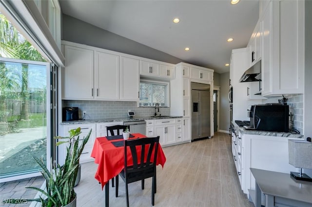 3708 Lorraine Ln, Las Vegas, NV 89120 - kitchen with stainless steel appliances, under cabinet range hood, tasteful backsplash, white cabinets, and recessed lighting