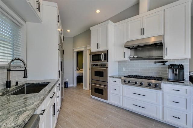3708 Lorraine Ln, Las Vegas, NV 89120 - kitchen featuring appliances with stainless steel finishes, under cabinet range hood, white cabinets, backsplash, and recessed lighting