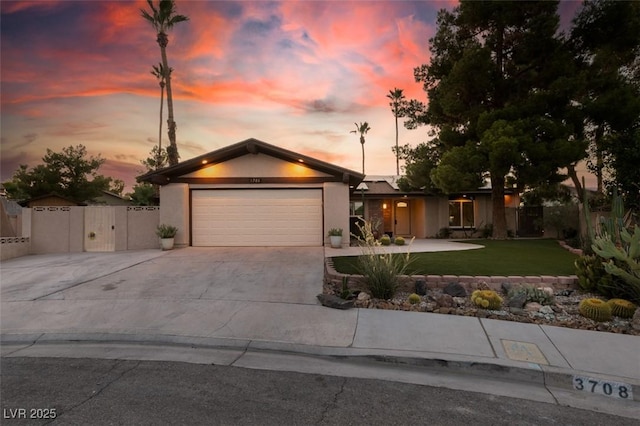 3708 Lorraine Ln, Las Vegas, NV 89120 - mid-century home with concrete driveway, an attached garage, a gate, and stucco siding