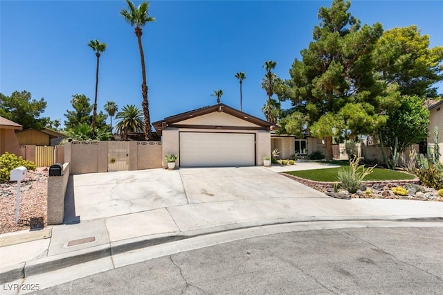 3708 Lorraine Ln, Las Vegas, NV 89120 - view of front of home with driveway, a garage, stucco siding, and a gate