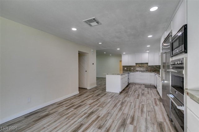 3708 Lorraine Ln, Las Vegas, NV 89120 - kitchen with appliances with stainless steel finishes, recessed lighting, light wood-style flooring, a peninsula, and backsplash